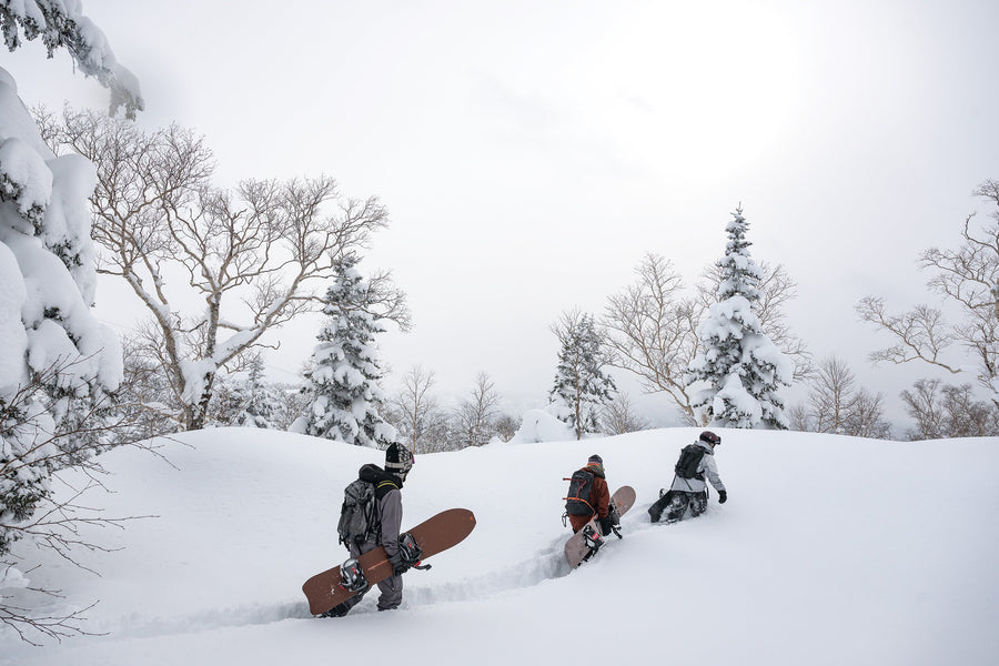 Robin Van Gyn leads Austen Sweetin and Nick Russell toward a classic tram-and-bootpack-accessed Asahidake tree run in Japan’s Kamikawa Subprefecture.